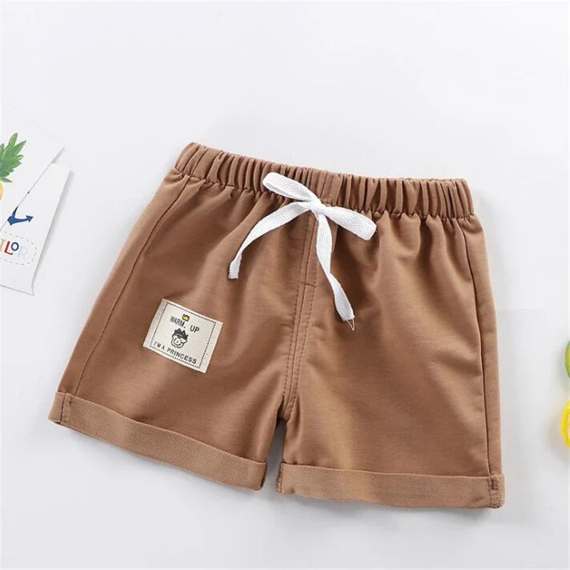 Set of multi-colored solid boys' summer shorts, essential baby clothing for active youngsters.
