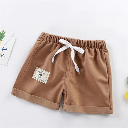 Set of multi-colored solid boys' summer shorts, essential baby clothing for active youngsters.