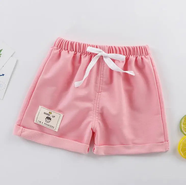 Pair of orange solid boys' summer shorts, great for beach or casual outings, soft polyester.