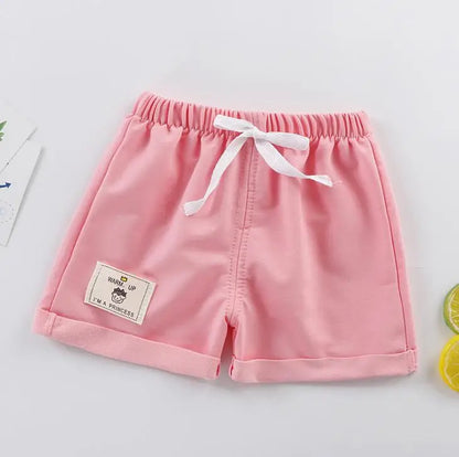 Pair of orange solid boys' summer shorts, great for beach or casual outings, soft polyester.