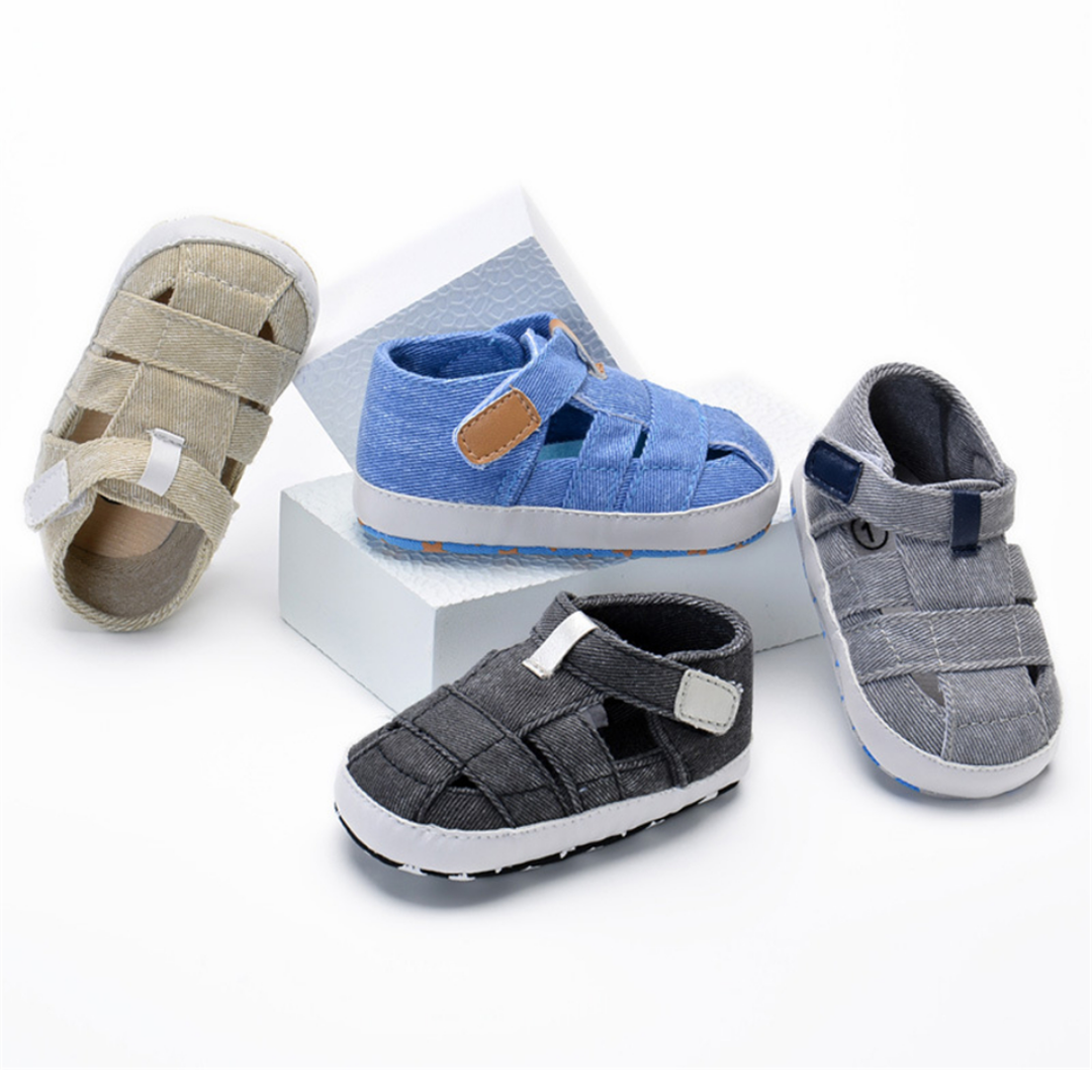 Side view of infant boy's canvas first walker sandals with flexible soft sole