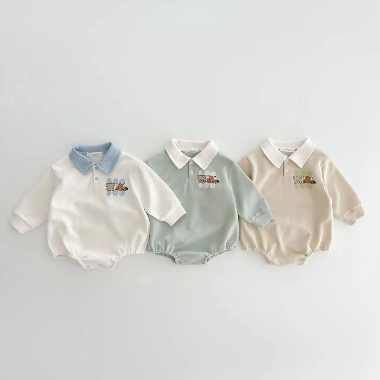 Close-up of a baby boys' cotton romper, highlighting the intricate cartoon embroidery.