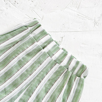 Close-up on the button detail of the green stripe lapel shirt in baby size