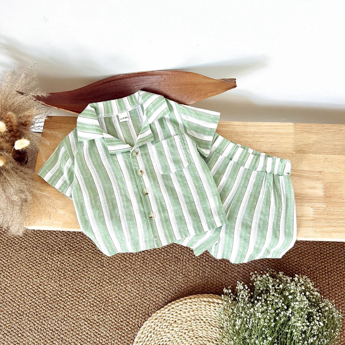 Two piece baby summer outfit: green stripe short-sleeve shirt and coordinating shorts