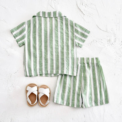 Baby clothing: green stripe shirt and shorts set folded neatly on a white surface