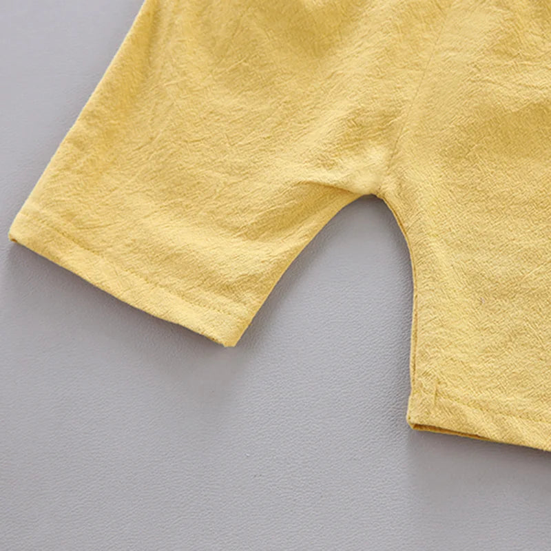 Cotton poplin baby set featuring modern pyramid pattern, short sleeves, and easy dressing