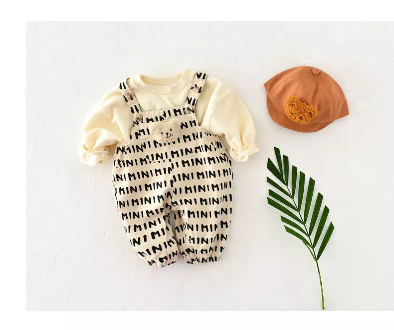 Back view of baby striped romper, showing full coverage and soft cotton material