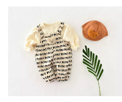 Back view of baby striped romper, showing full coverage and soft cotton material