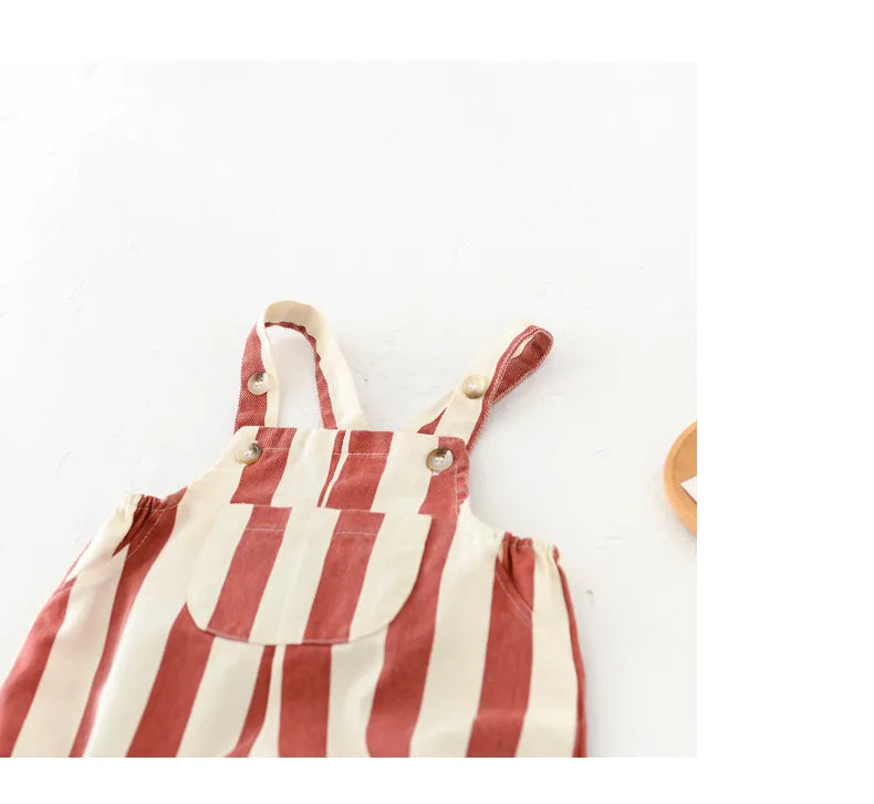 Playful baby in striped romper, crawling, showcasing comfort of cotton playsuit