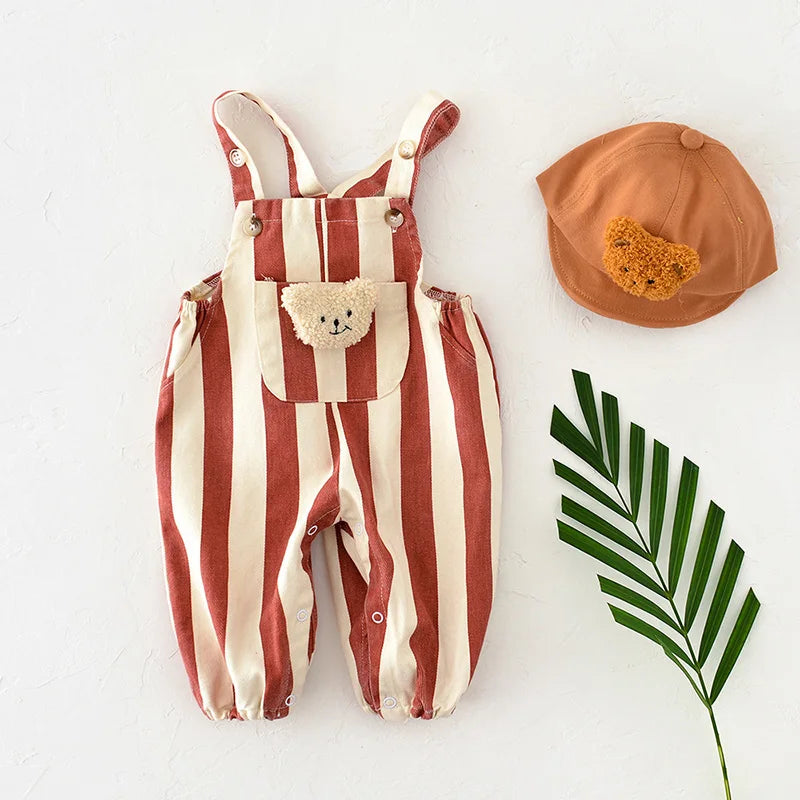 Baby model wearing grey and white striped romper, playful newborn spring outfit fashion