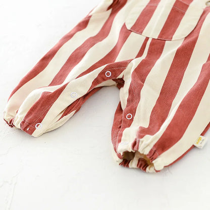 Full view of baby striped romper, highlighting easy dressing snap closure for infant use