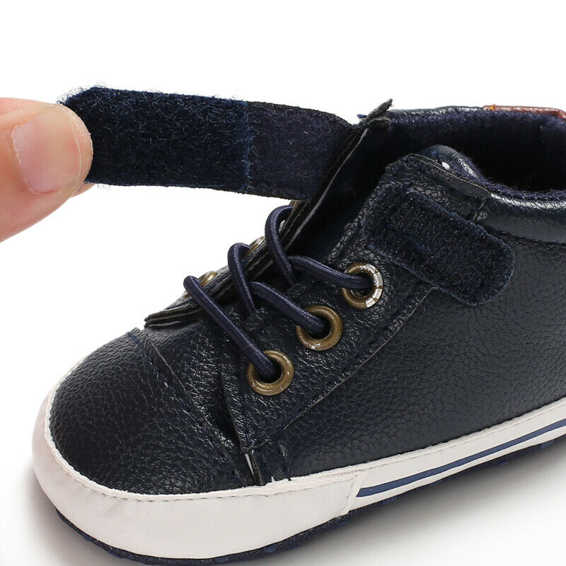 Pair of baby boys' leather first walker infant shoes with anti-slip bottom for toddlers.
