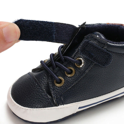 Pair of baby boys' leather first walker infant shoes with anti-slip bottom for toddlers.