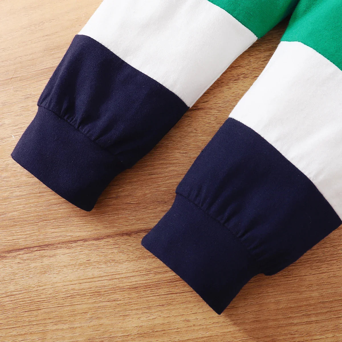 Complete laid-flat view of baby boy's sporty casual printed top & solid long pant set
