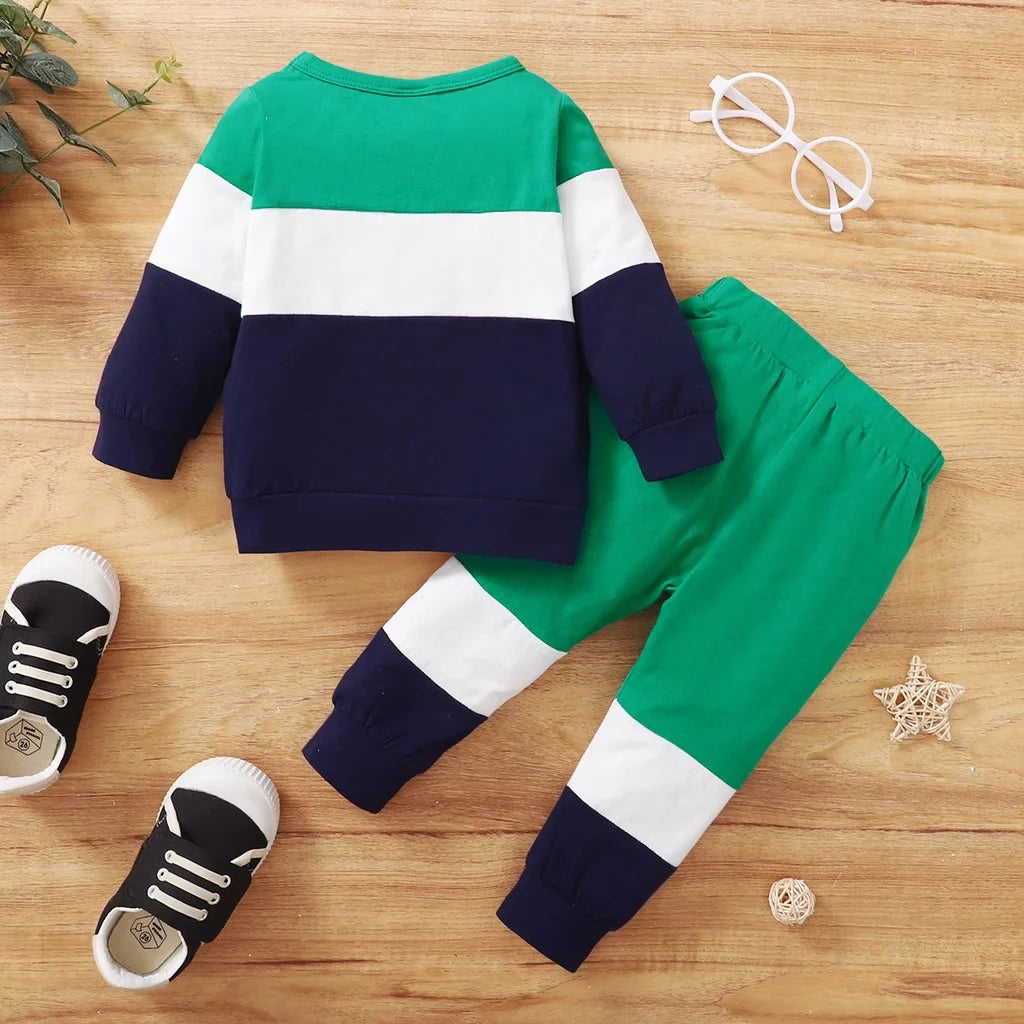 Full view of baby boy in blue sport casual print top and gray long pant set