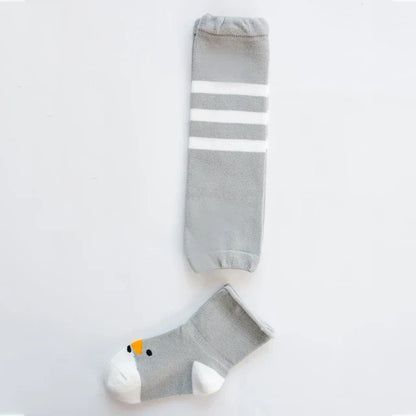 Close-up of a baby's leg with cartoon knee pad leg warmer, cotton, crawling aid
