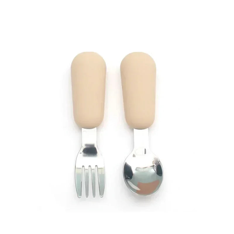 Detailed view of a cartoon animal handle on a stainless steel toddler fork, kids tableware