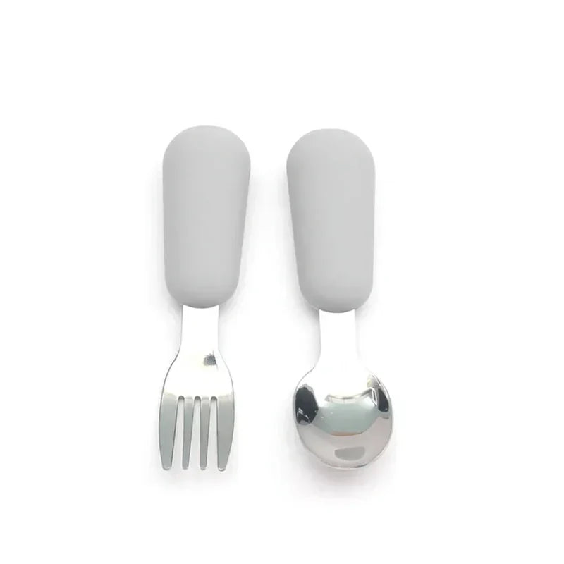 BPA-free stainless steel baby spoon with a cheerful cartoon design, suitable for weaning