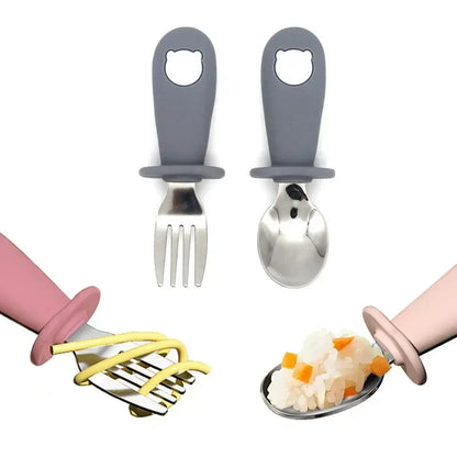 Toddler feeding set: stainless steel spoon and fork with green cartoon animal handles, weaning tools