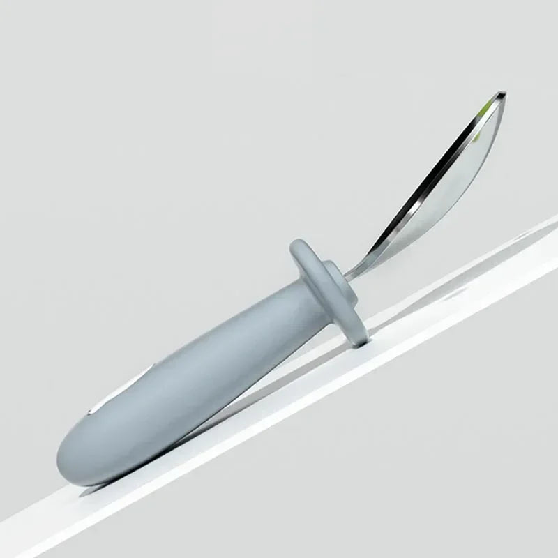 Close-up of a baby's first cutlery, stainless steel fork with a yellow cartoon lion handle, BPA-free