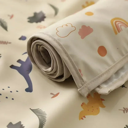 Baby changing mat: waterproof, reusable diaper pad with playful animal design.