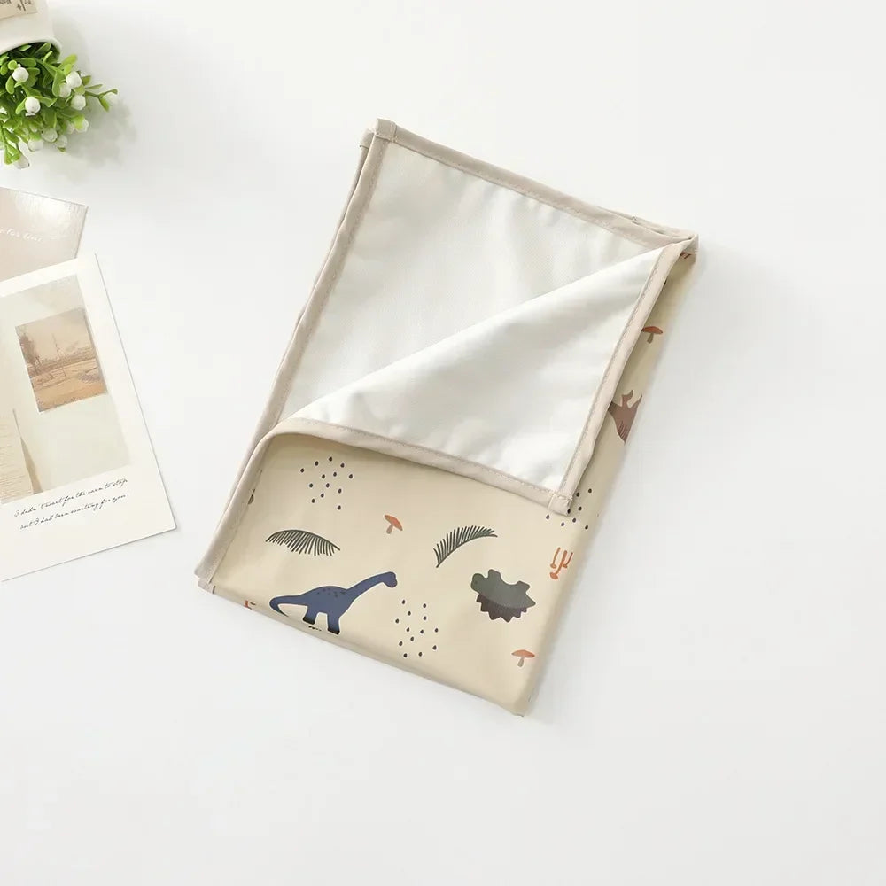 Baby accessory: changing mat with a secure, non-slip backing, easy to clean.
