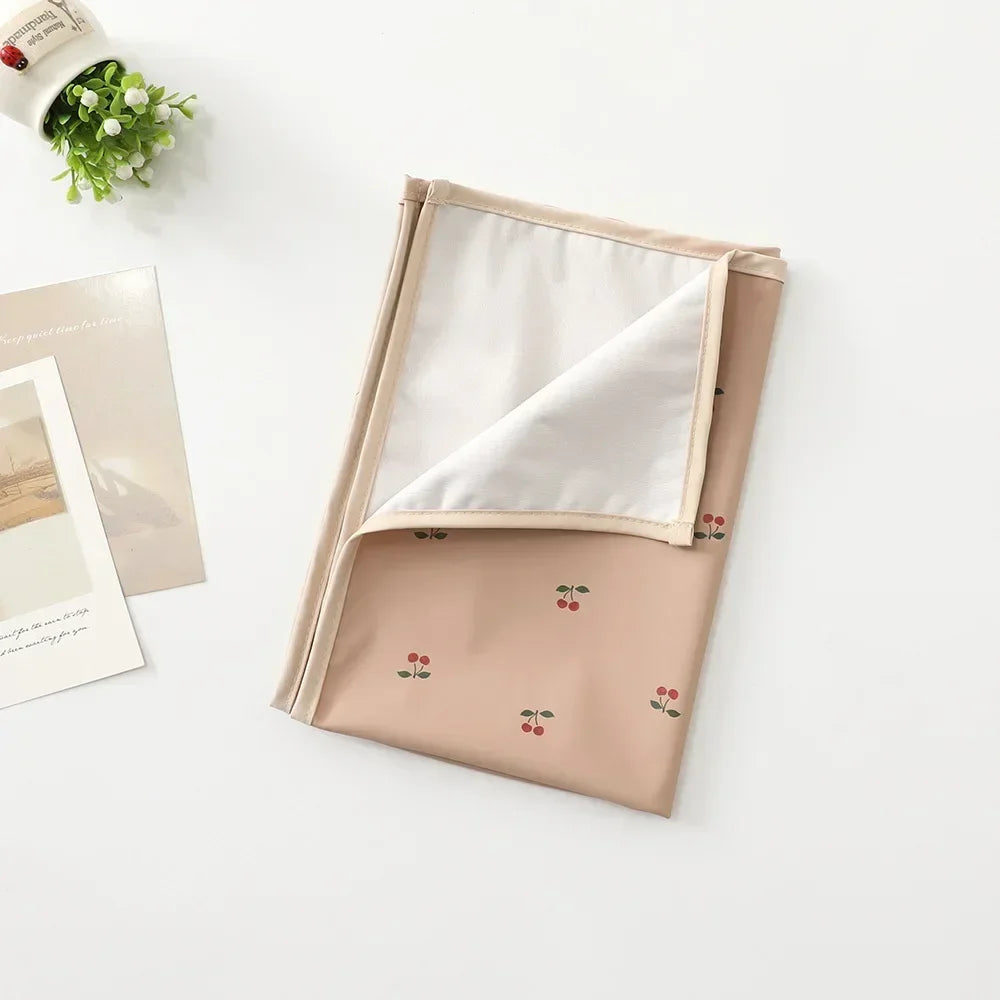Changing pad illustrating its waterproof functionality, ideal for messy changes.