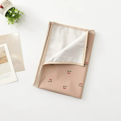 Changing pad illustrating its waterproof functionality, ideal for messy changes.