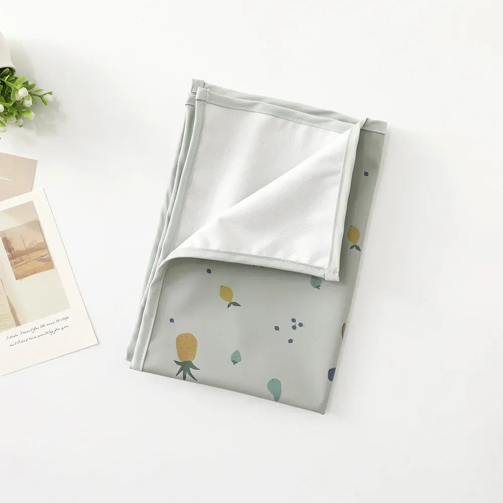 Essentials for new baby: waterproof and reusable diaper pad on a clean surface.