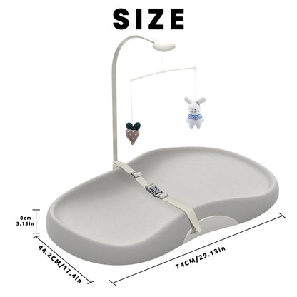 Portable baby changing pad featuring a secure safety strap and attached toy bar for engaging infants.