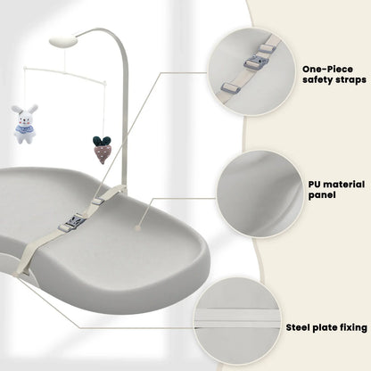 Wipe-clean baby changing pad with safety strap and playful toy bar, ideal for baby care and diaper duty.