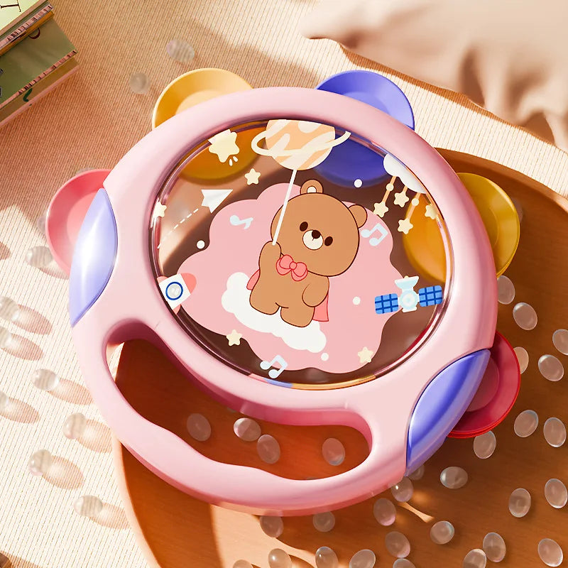 Toddler holding an educational rhythm tambourine toy, perfect for engaging musical activity and learning