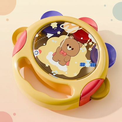 Happy infant playing with an educational musical tambourine toy, ideal for sensory development and rhythm practice