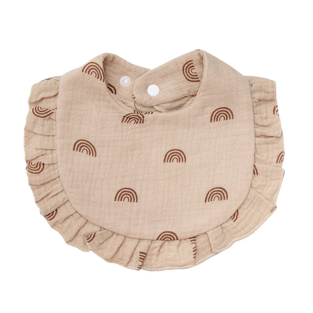 Practical and soft cotton baby bib, decorated with a flower print and equipped with an adjustable snap.
