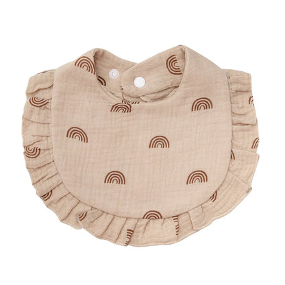 Practical and soft cotton baby bib, decorated with a flower print and equipped with an adjustable snap.