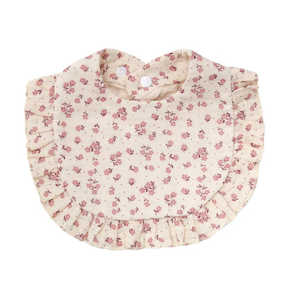 Close-up of the adjustable snap on a baby cotton flower print bib, highlighting its functionality.