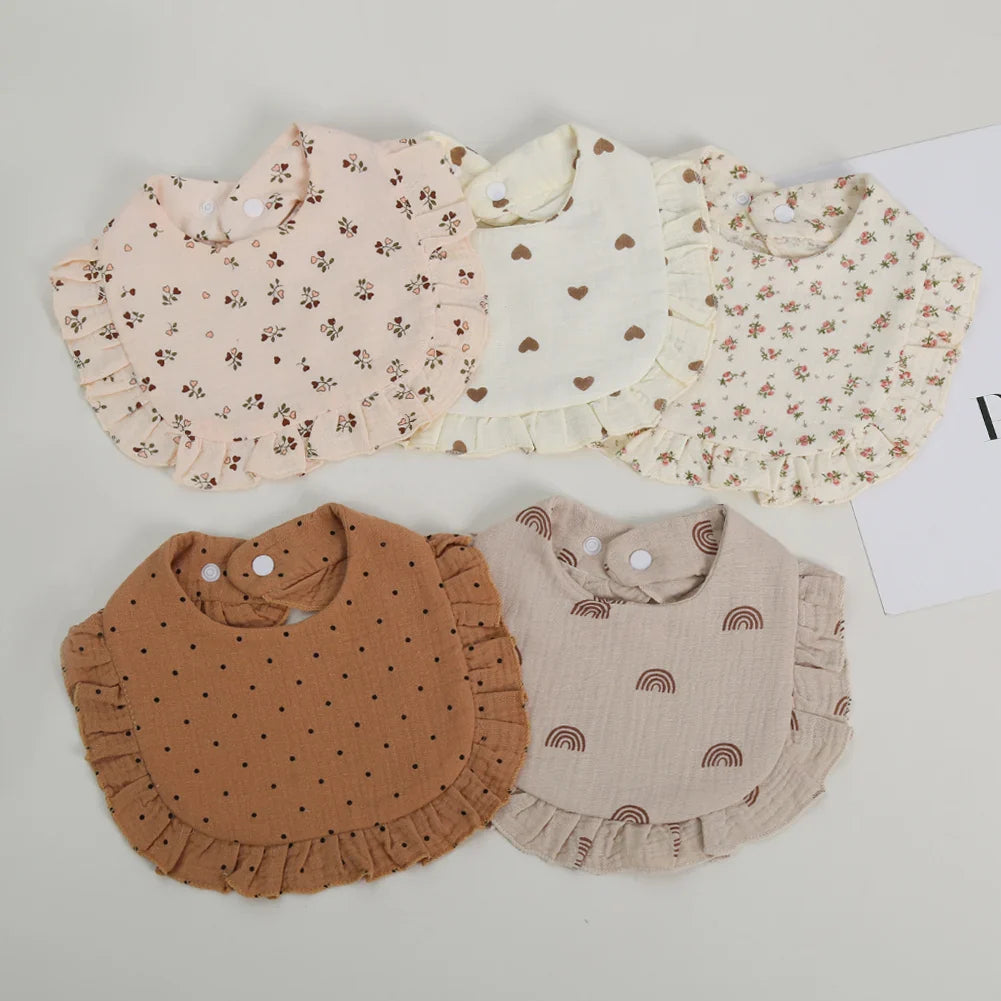 Baby bib made from soft cotton, adorned with a lovely flower print and practical adjustable snap.