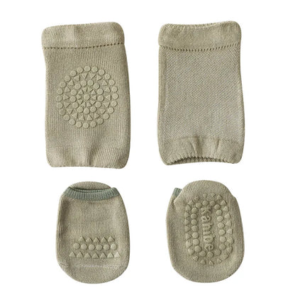 Overhead view of two pairs of baby knee pads and two pairs of anti-slip socks in various colors.