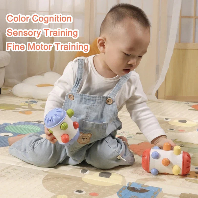 Infant grasping a fabric loop on a textured Baby Sensory Crawl & Grasp roll toy
