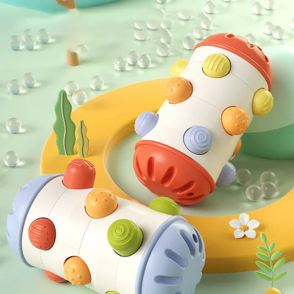 Smiling baby engaging in sensory play with a multi-textured developmental roll toy