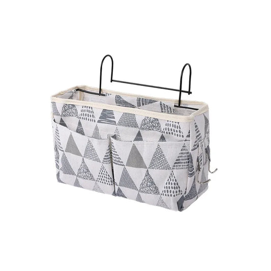 Baby crib hanging storage organizer in linen, perfect for nursery decor and newborn essentials.