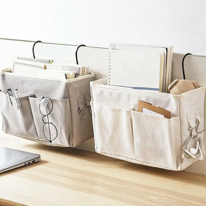 Compact diaper caddy and bedside storage bag hangs on a crib, ideal for baby essentials.