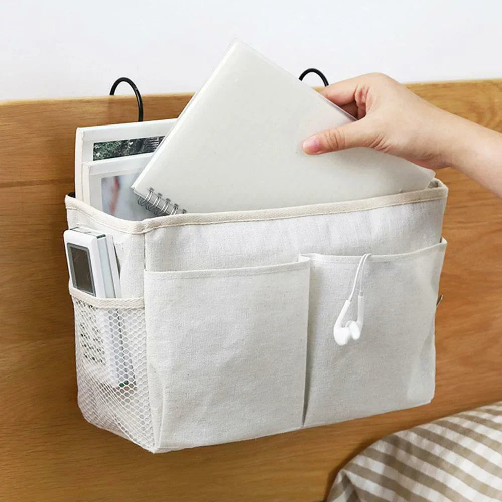 Baby crib hanging organizer with multiple compartments, essential for diaper changes and newborn care.
