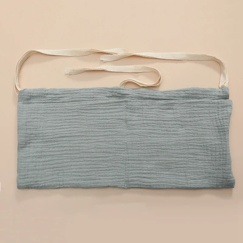 Diaper caddy solution: cotton crib organizer, perfect for quick diaper changes in the nursery.