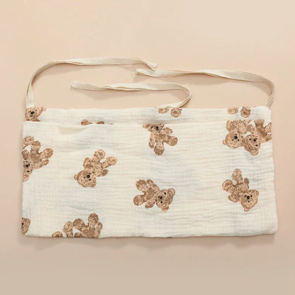 Stylish patterned cotton crib storage bag, enhancing nursery decor while providing utility.