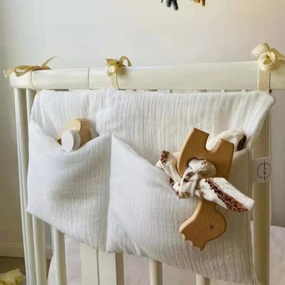 Eco-friendly cotton baby organizer, attaches to crib rail for convenient storage of daily items.