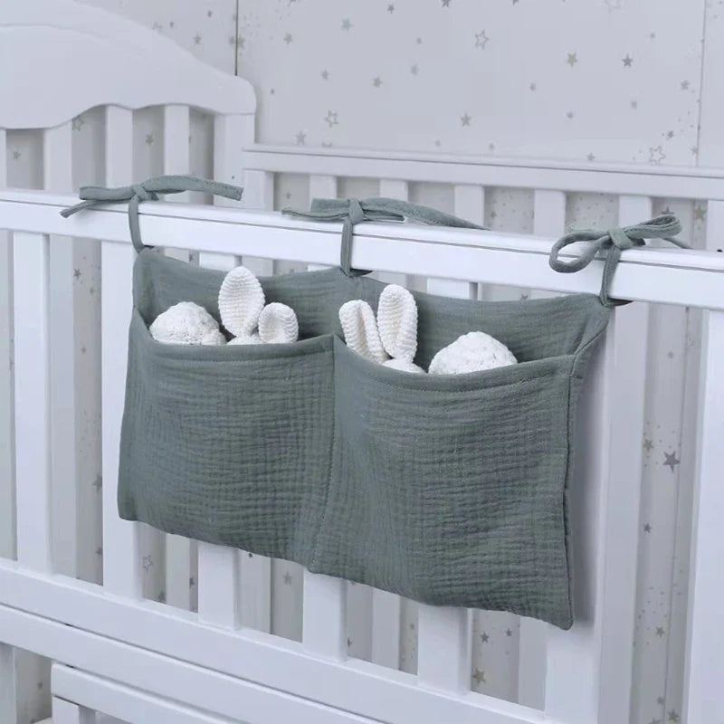 Multifunctional baby storage bag for cribs, holding diapers, wipes, and lotion, organized nursery.