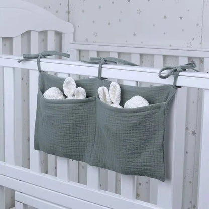 Multifunctional baby storage bag for cribs, holding diapers, wipes, and lotion, organized nursery.