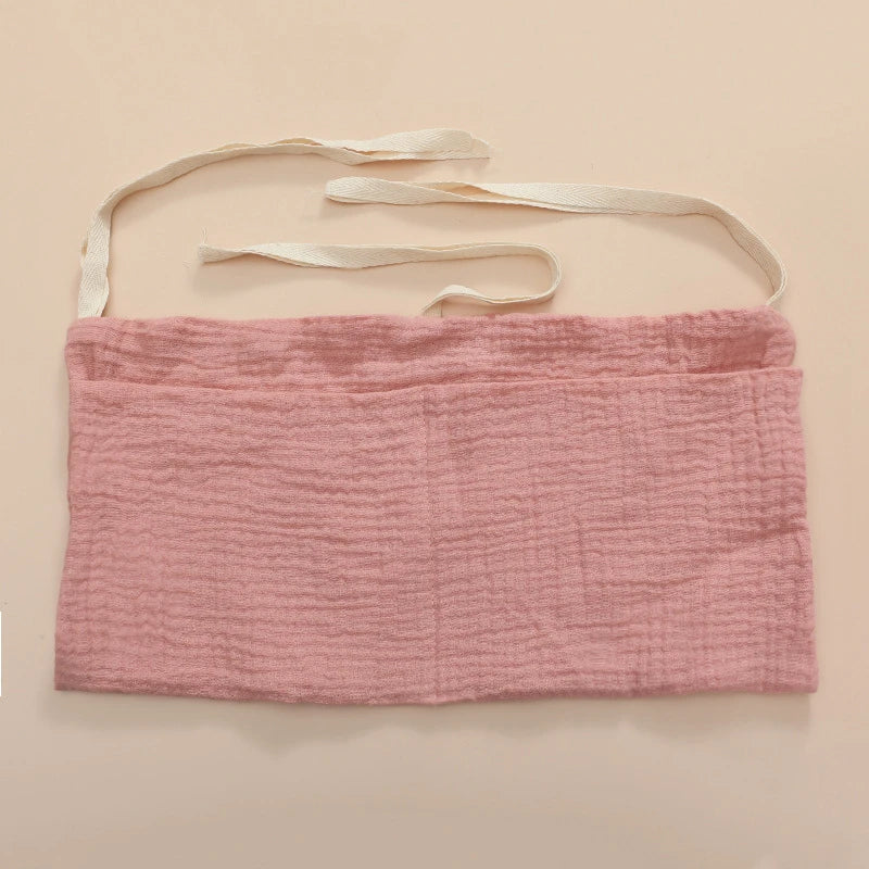 Neutral-toned cotton crib storage bag, a stylish and functional nursery decor addition.