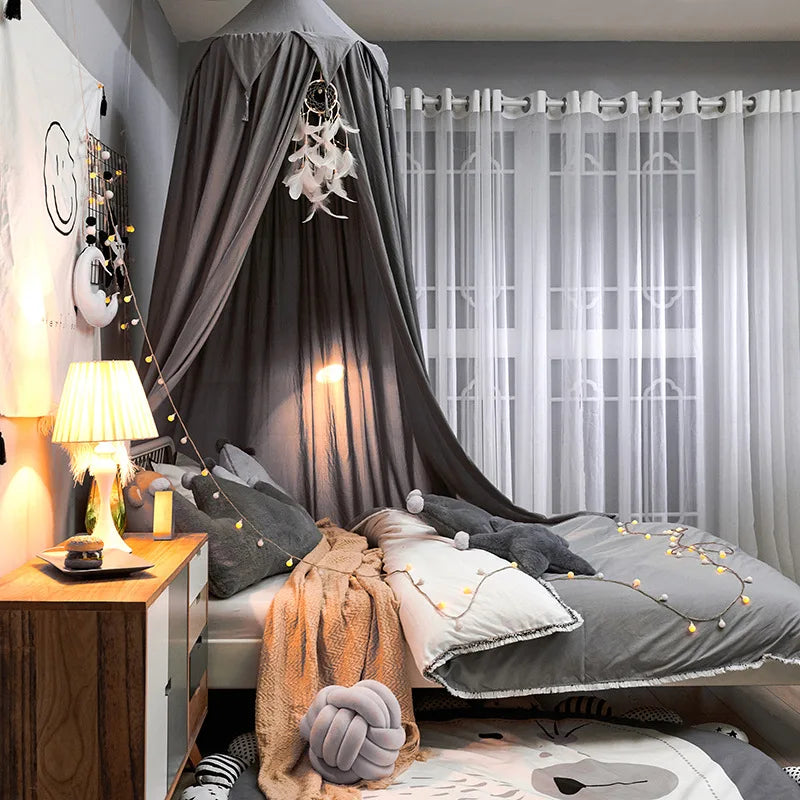 Portable baby dome mosquito net draped over a travel crib, ideal for outdoor baby safety